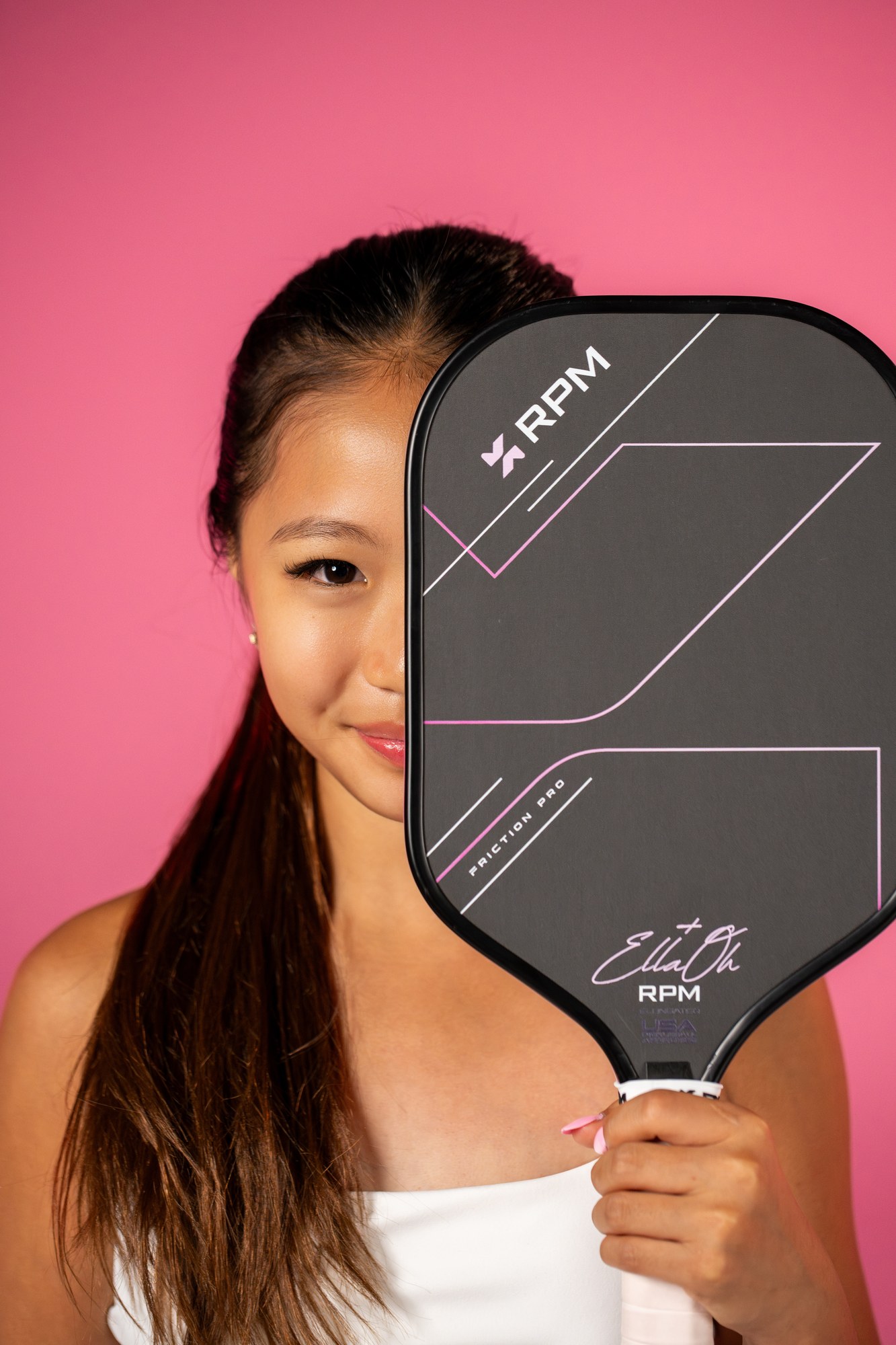 Ella Oh holding her RPM signature pickleball paddle